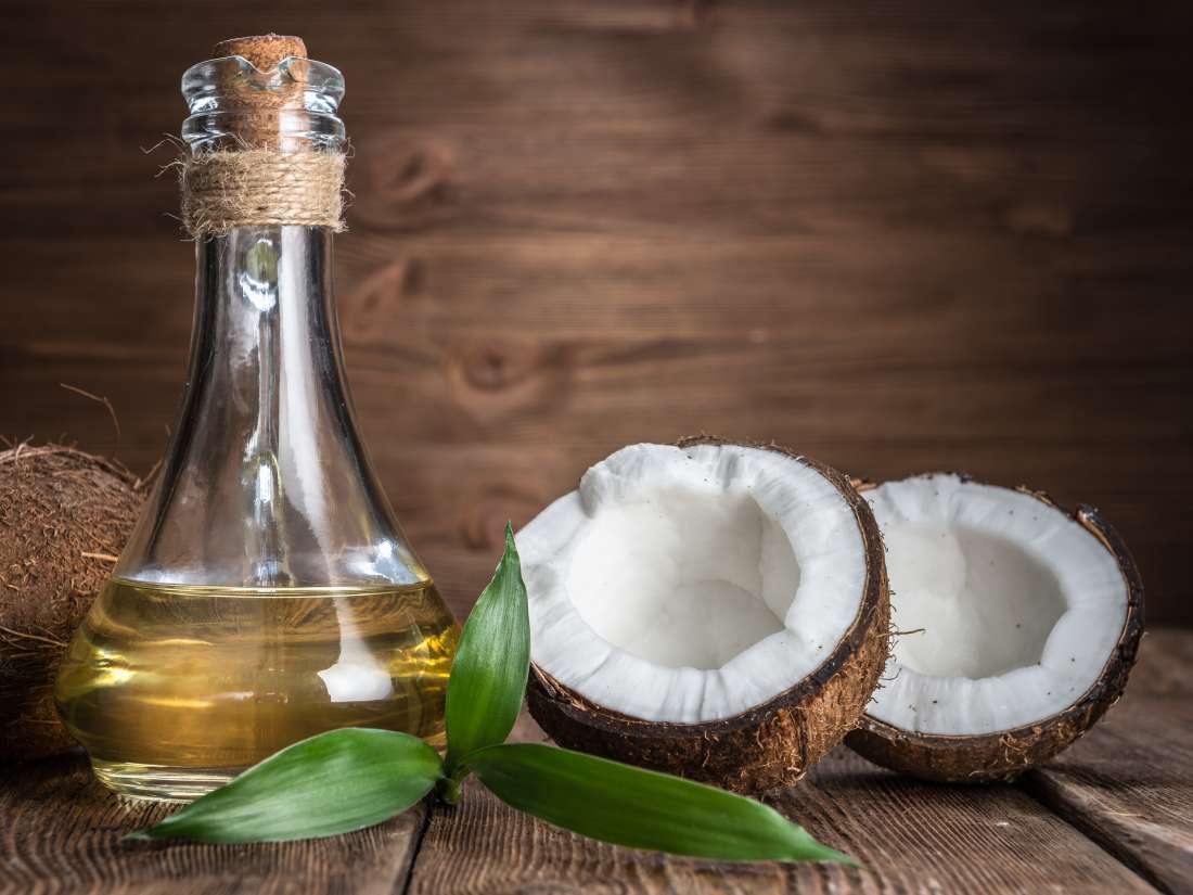 Coconut oil bottle with coconuts